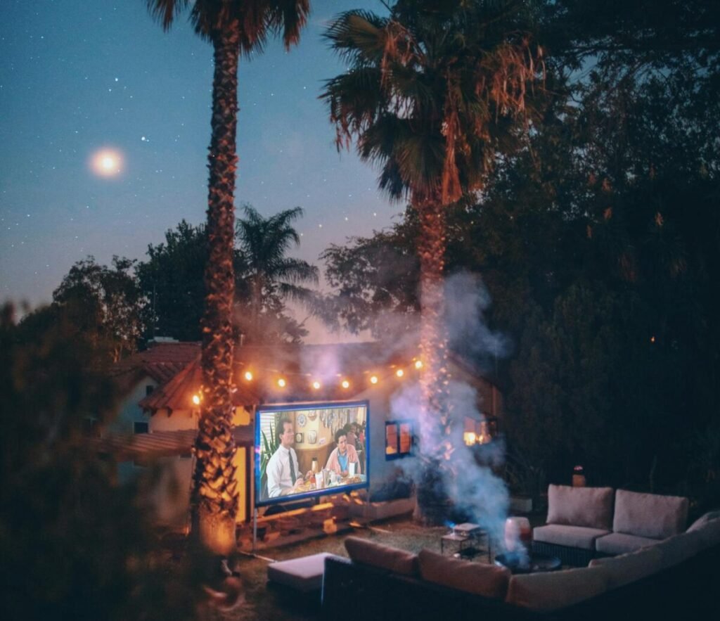 Relaxing outdoor movie night setup with projector under a starry sky in Los Angeles.